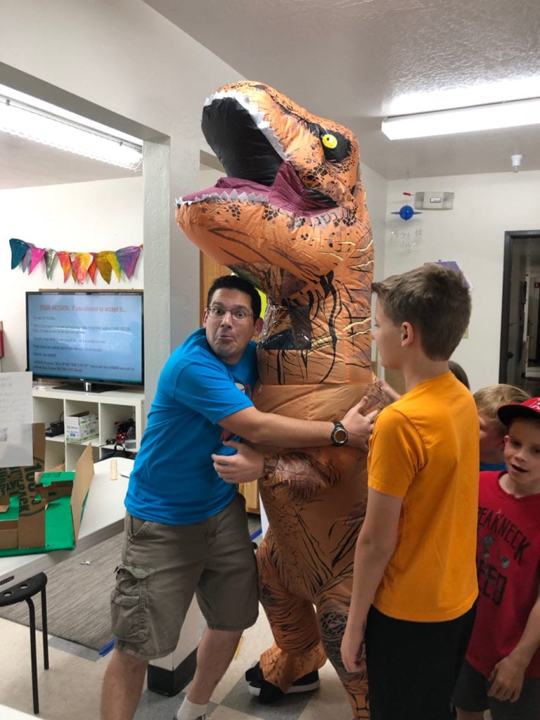 Mr Carras hugging a T-Rex